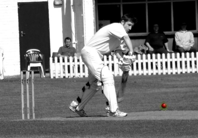 cricket player and ball bw