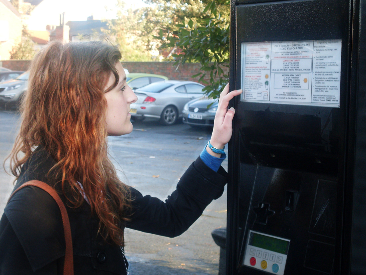 Woman at parking ticket machine