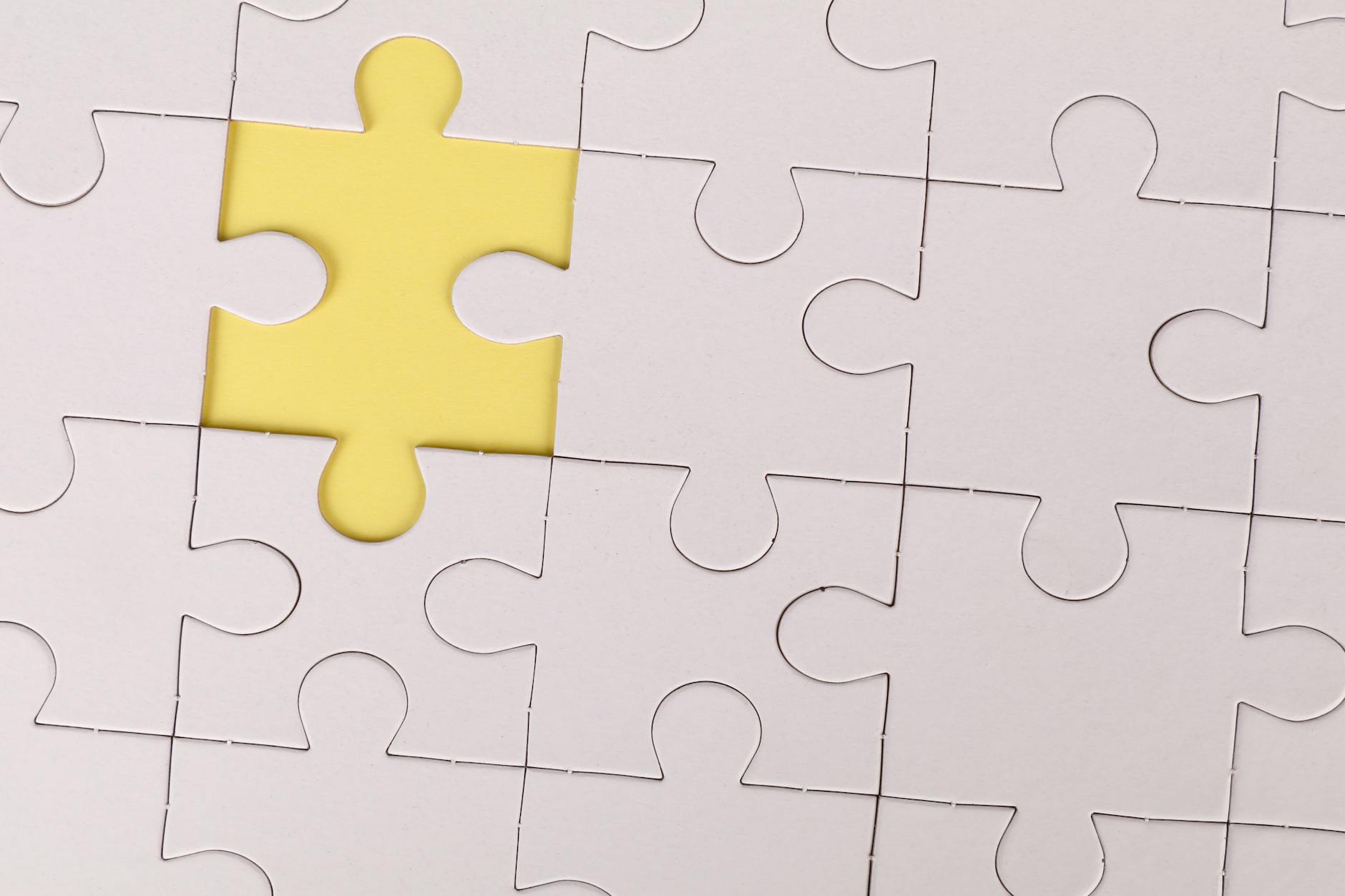 Yellow Jigsaw Piece out of Puzzle