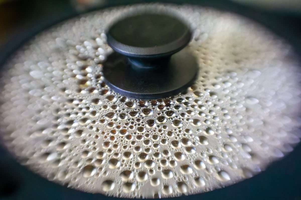 A photo of a pan lid covered with bubbles generated from hot steam