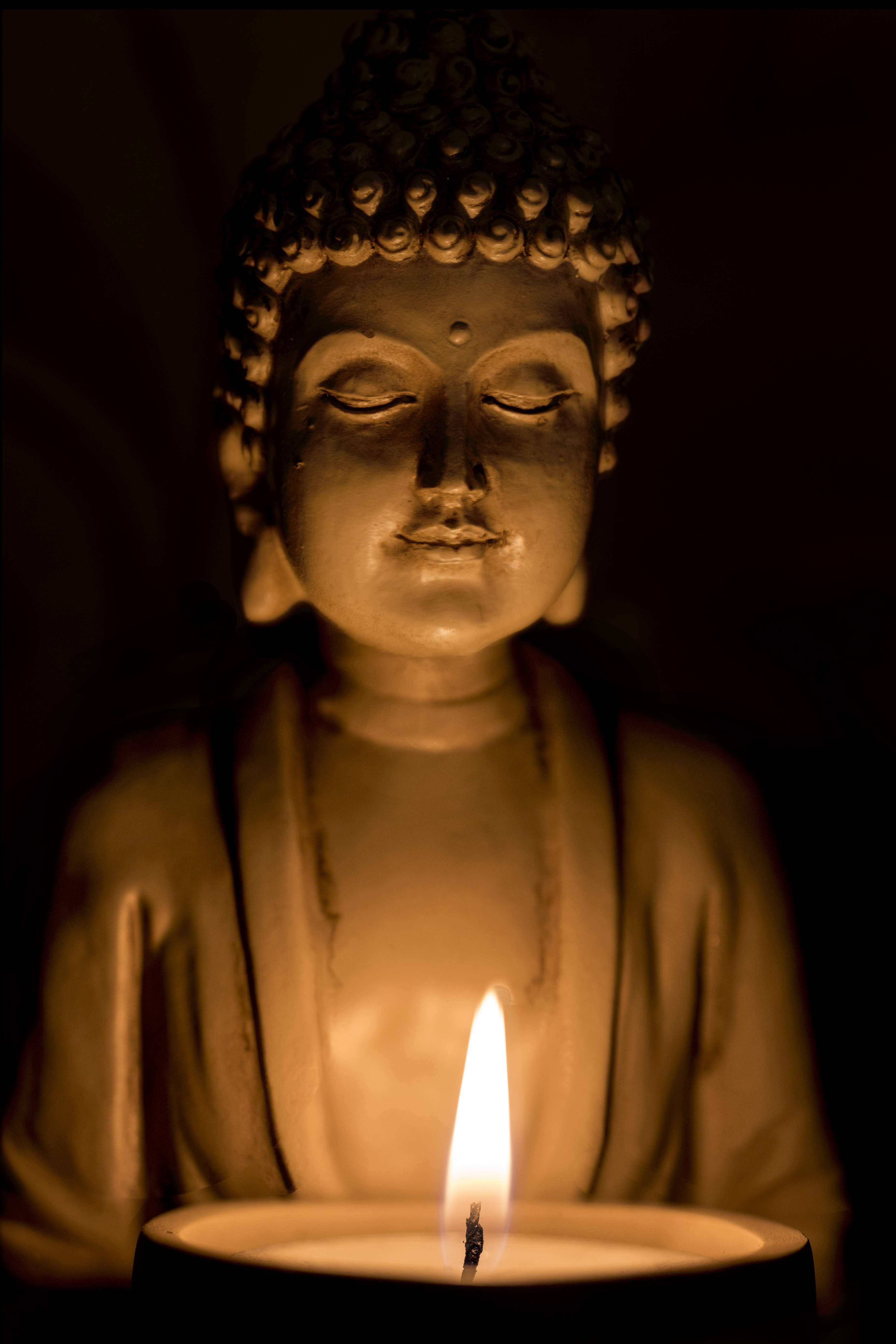 Buddha lit by candle